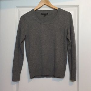 Grey sweater with silver beads.